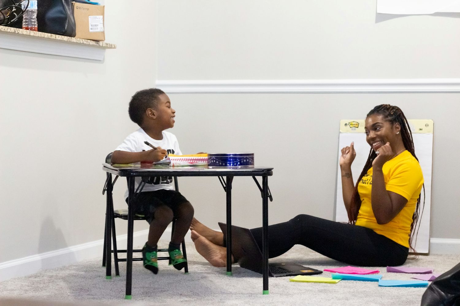 Mother and son writing together